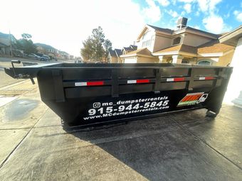 yellow dumpster in the walkway
