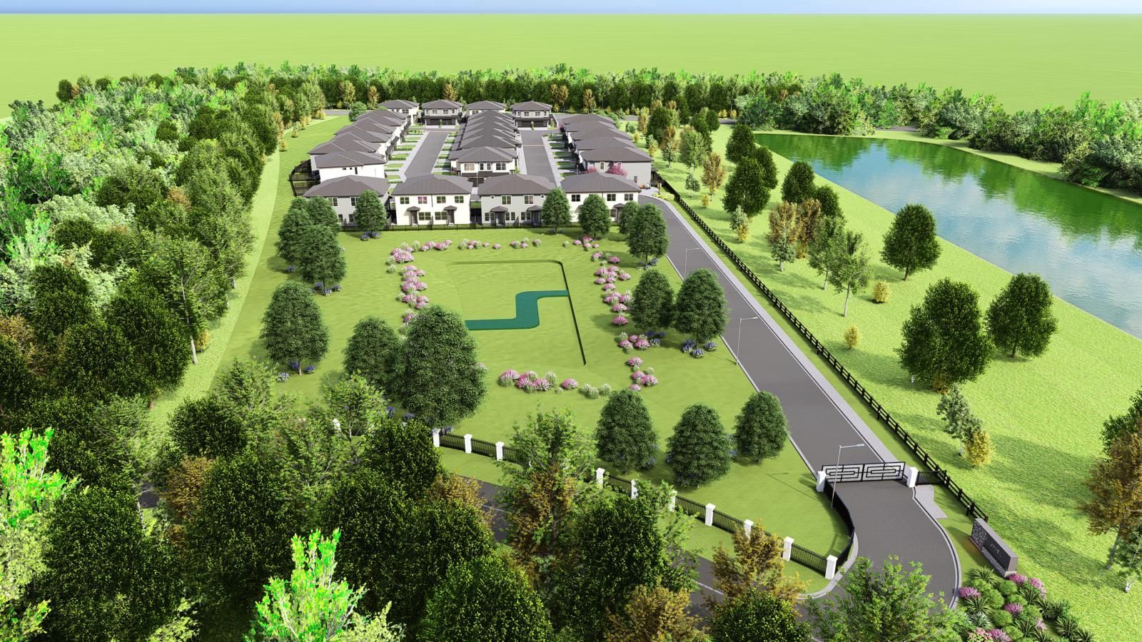 Aerial view of a large house, manicured lawn, driveway, and trees beside a river.
