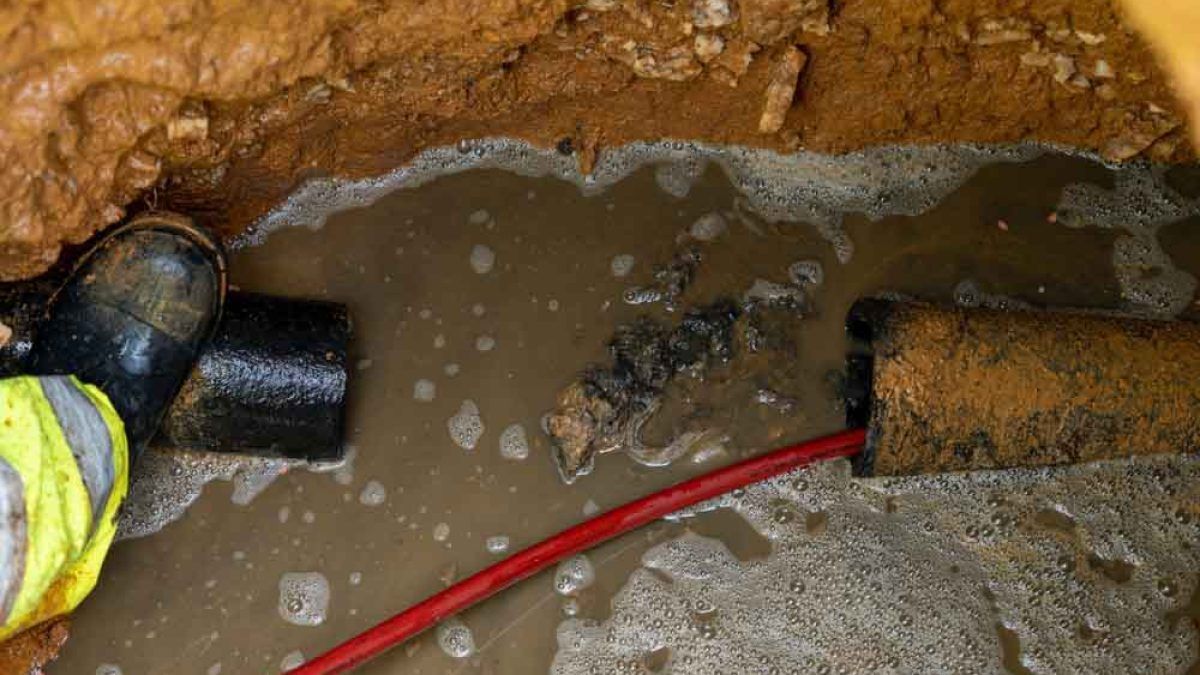 A person is working on a broken pipe in the ground. Northglenn, Colorado accountable home services
