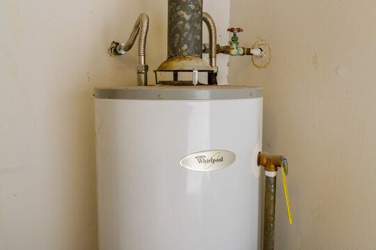 A white water heater is sitting in a corner of a room. Northglenn, Colorado accountable home services