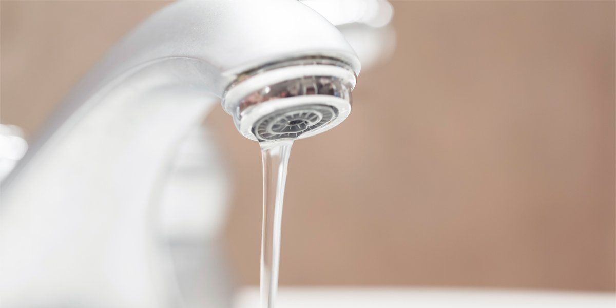 Water is dripping from a white faucet in a bathroom. Northglenn, Colorado accountable home services