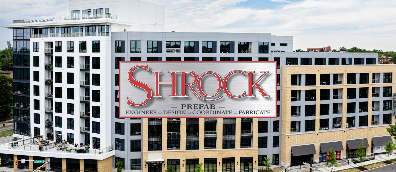A large building with the Shrock Prefab logo in the foreground. 