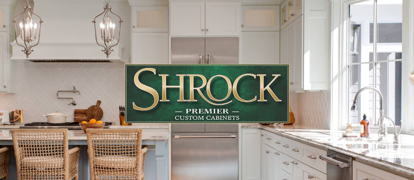 A kitchen with the Shrock Premier Custom Cabinets logo in the foreground. 