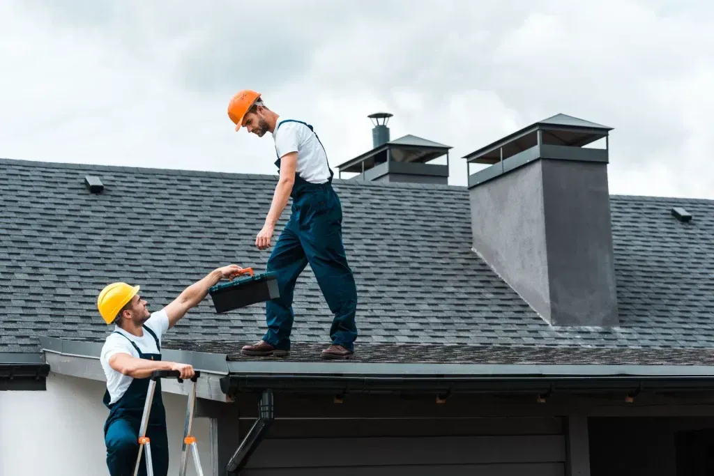 Two roofers on a roof
