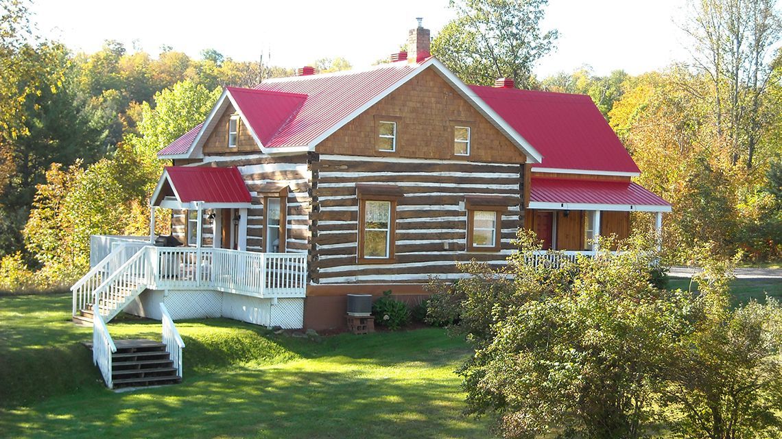 Log cabin with a bright red roof