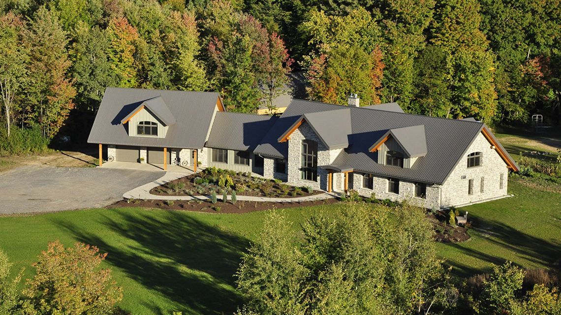 stone-clad house with a grey roof