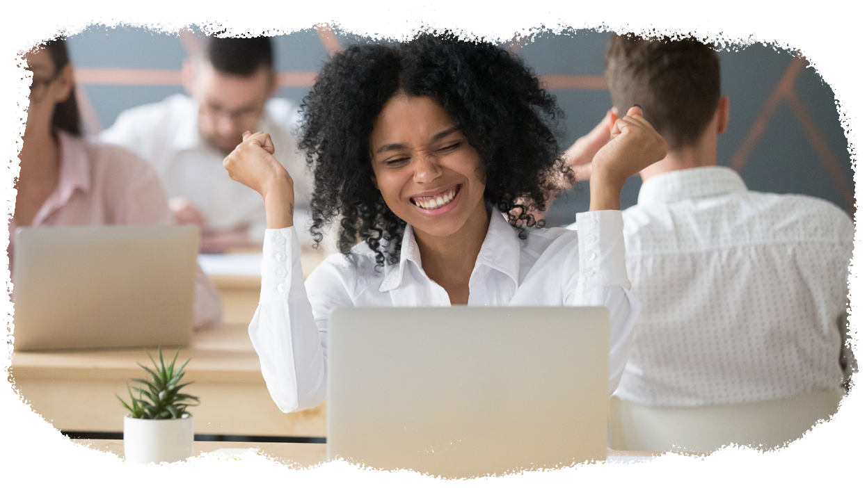 A fulfilled and happy employee celebrates in the office.