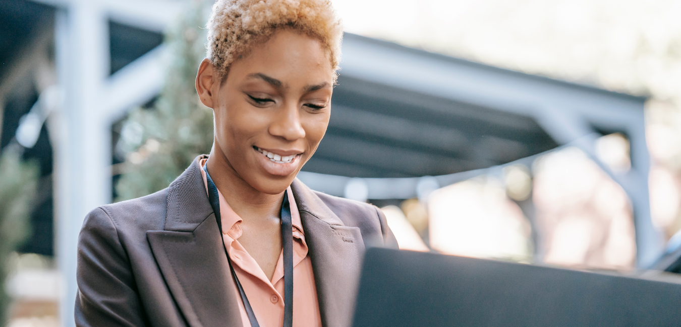 Young professional woman using her laptop as she applies for work
