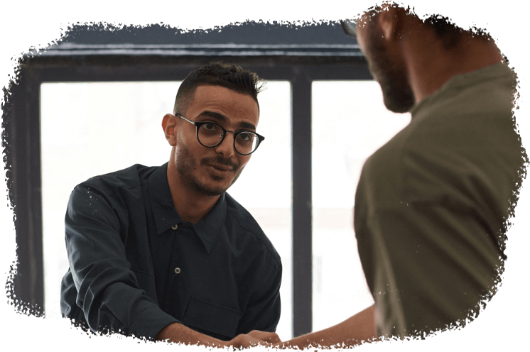 young man happily shaking hands with his helpful life coach