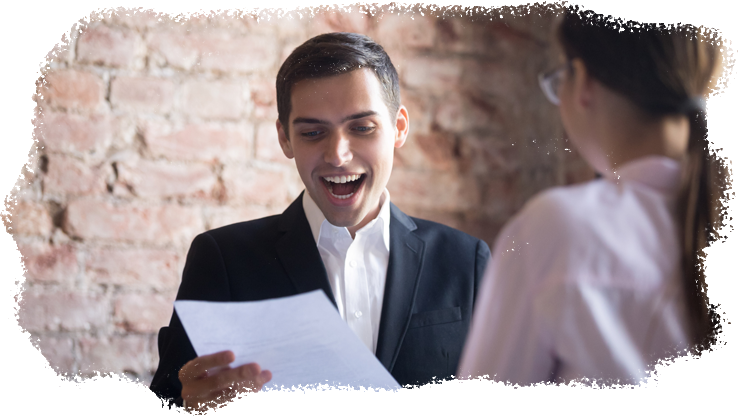A young man smiles and speaks confidently during a job interview.