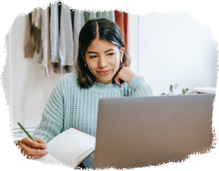 A young woman uses a laptop to search for a new job.