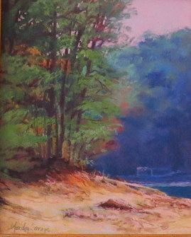 Pastel landscape of sandy shore, green trees, blue water, and pink sky.