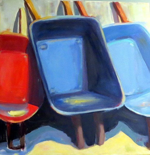 Colorful stadium seats in red, dark blue, and light blue viewed close up.