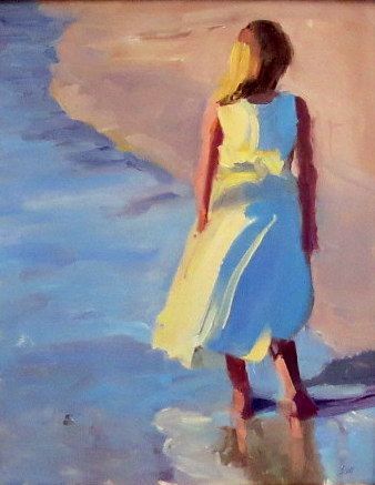 Girl in a white dress standing at the shoreline, seen from behind, with blue water and sandy beach.