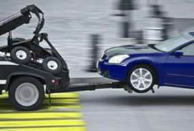 Picture of a blue car being towed away by a towing Coquitlam