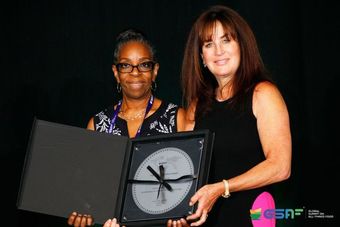 Owner with award Jennifer