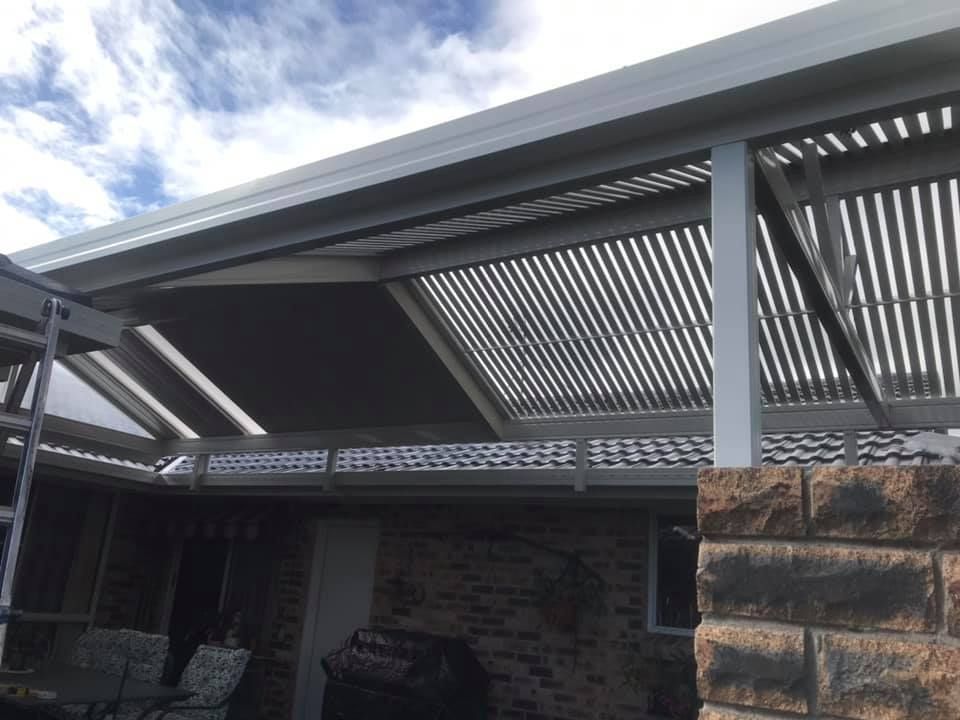 The roof of a house with a striped roof and a ladder.