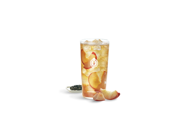 Juicy peach slices beside Guiji Peach Oolong Tea served over ice in a clear glass cup.