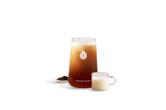Classic, nutty Taiwanese Black Milk Tea served over ice with creamy milk and loose black tea leaves.