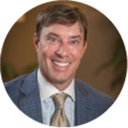 A man in a suit and tie is smiling in a circle