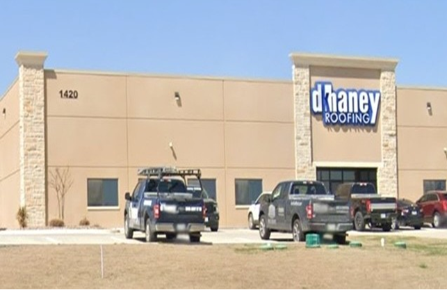A large building with a parking lot in front of it