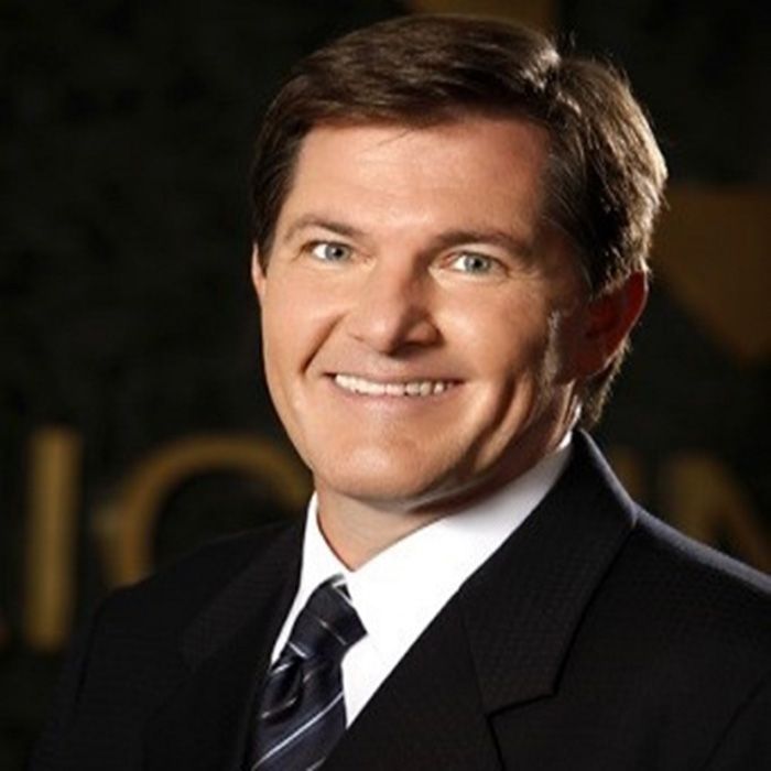 A man in a suit and tie smiles for the camera