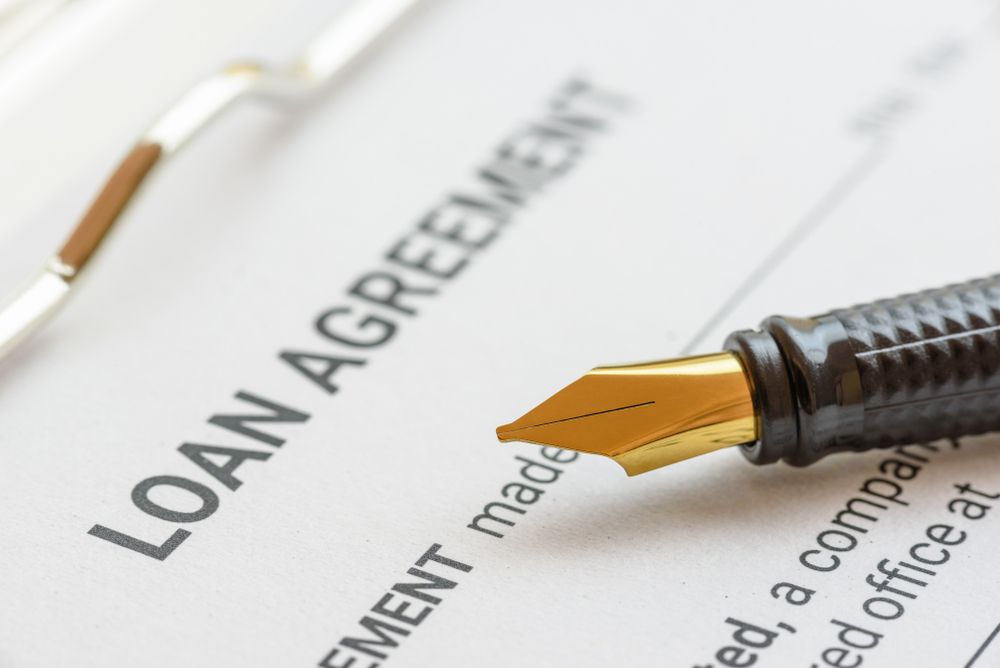 A Fountain Pen is Sitting on Top of a Loan Agreement — Rauseo Group in Zuccoli, NT