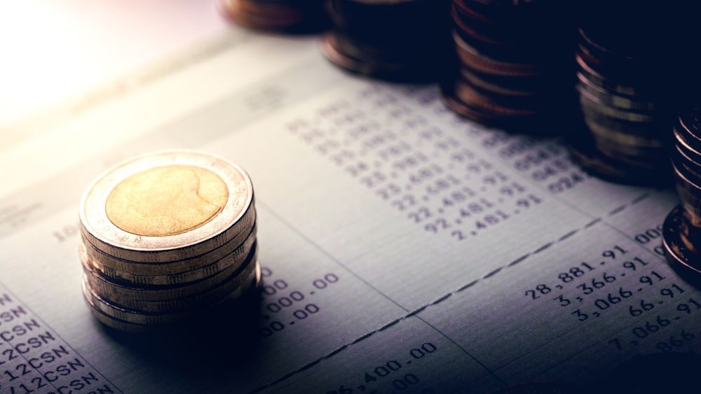 A Stack of Coins Sitting on Top of a Receipt — Rauseo Group in Zuccoli, NT