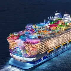A large cruise ship is floating on top of a body of water.