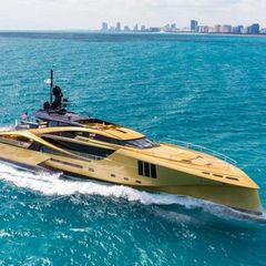 A large yellow yacht is floating in the ocean