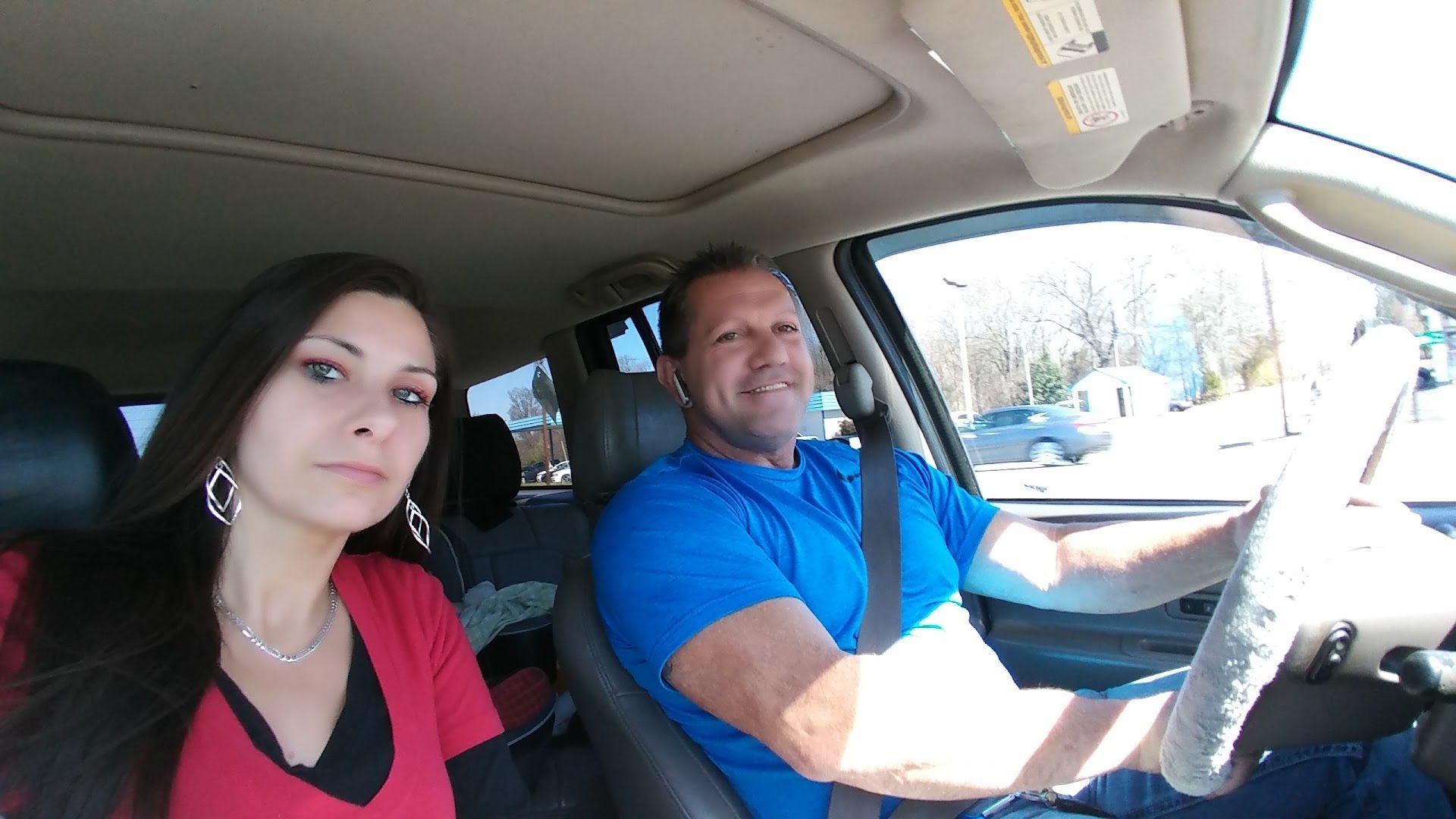 Man And Woman Seated Inside A Vehicle | Diagnostic Shop