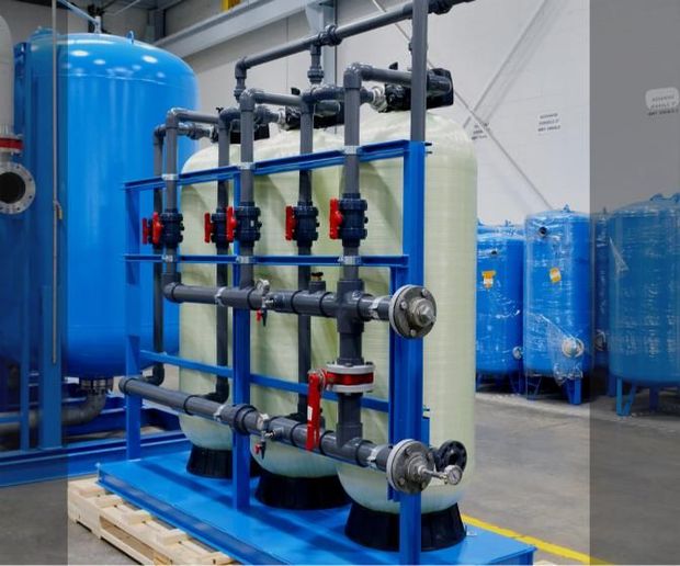 Water streaming down a narrow industrial corridor with white walls and a dark floor