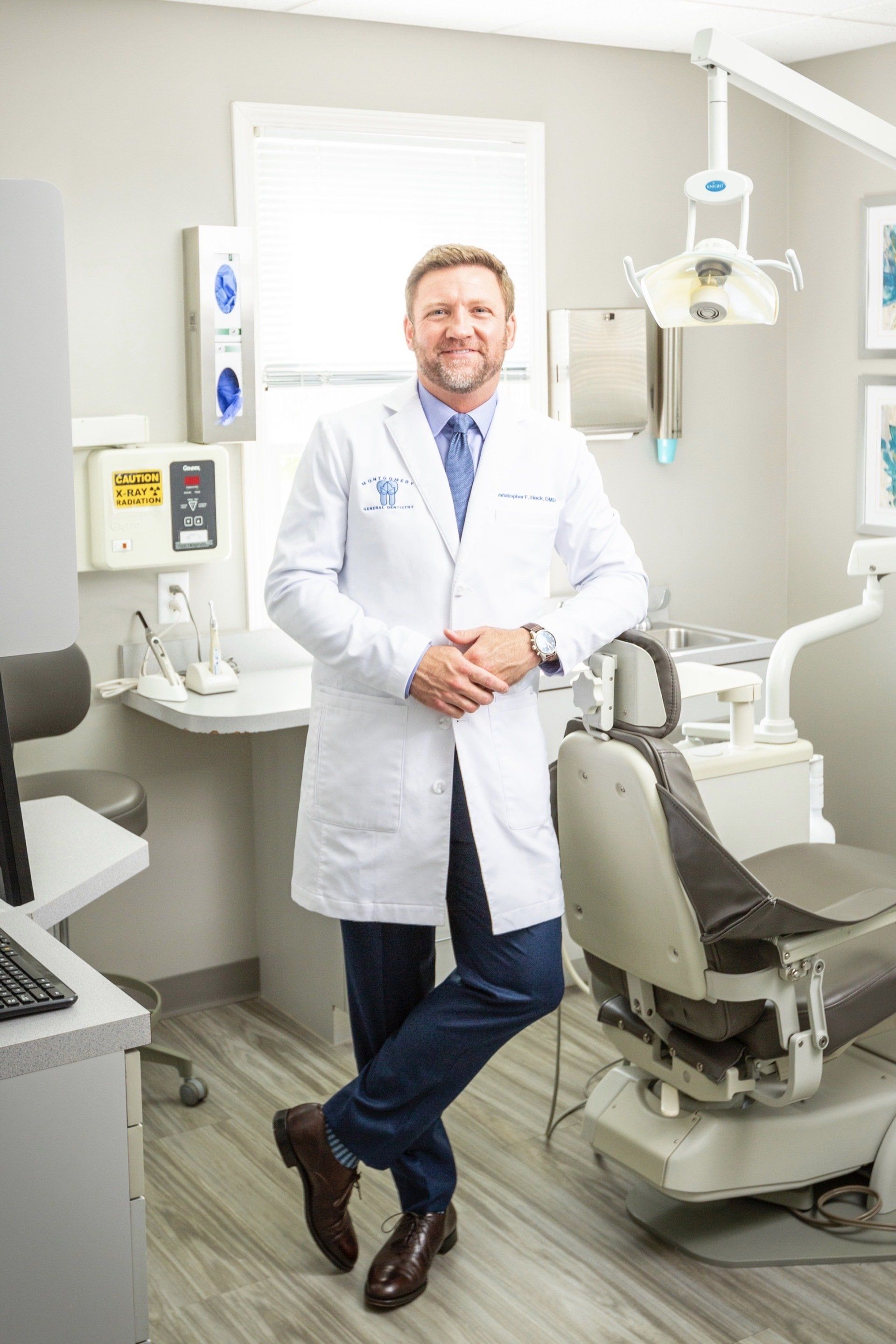 Dr. Heck in front of Montgomery General Dentistry sign in Montgomery, OH