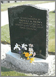 Traditional ogee head in Black granite with white shaded roses and option to inscribe a monogram in the scroll.