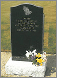 A tall elegant stone in the classic Black granite with sanded 'Praying Hands'.
