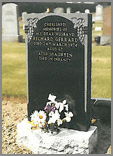 Black granite straight top head with sanded deep carved grape design and stopped sanded margin.