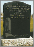 Classic Black granite ogee head with sanded church window design in bottom left hand corner. Mounted onto a Light Grey oblong base.