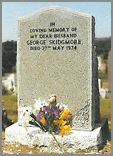 Karin Grey ogee shaped head with sanded margin and deep carved flower design at bottom of stone.