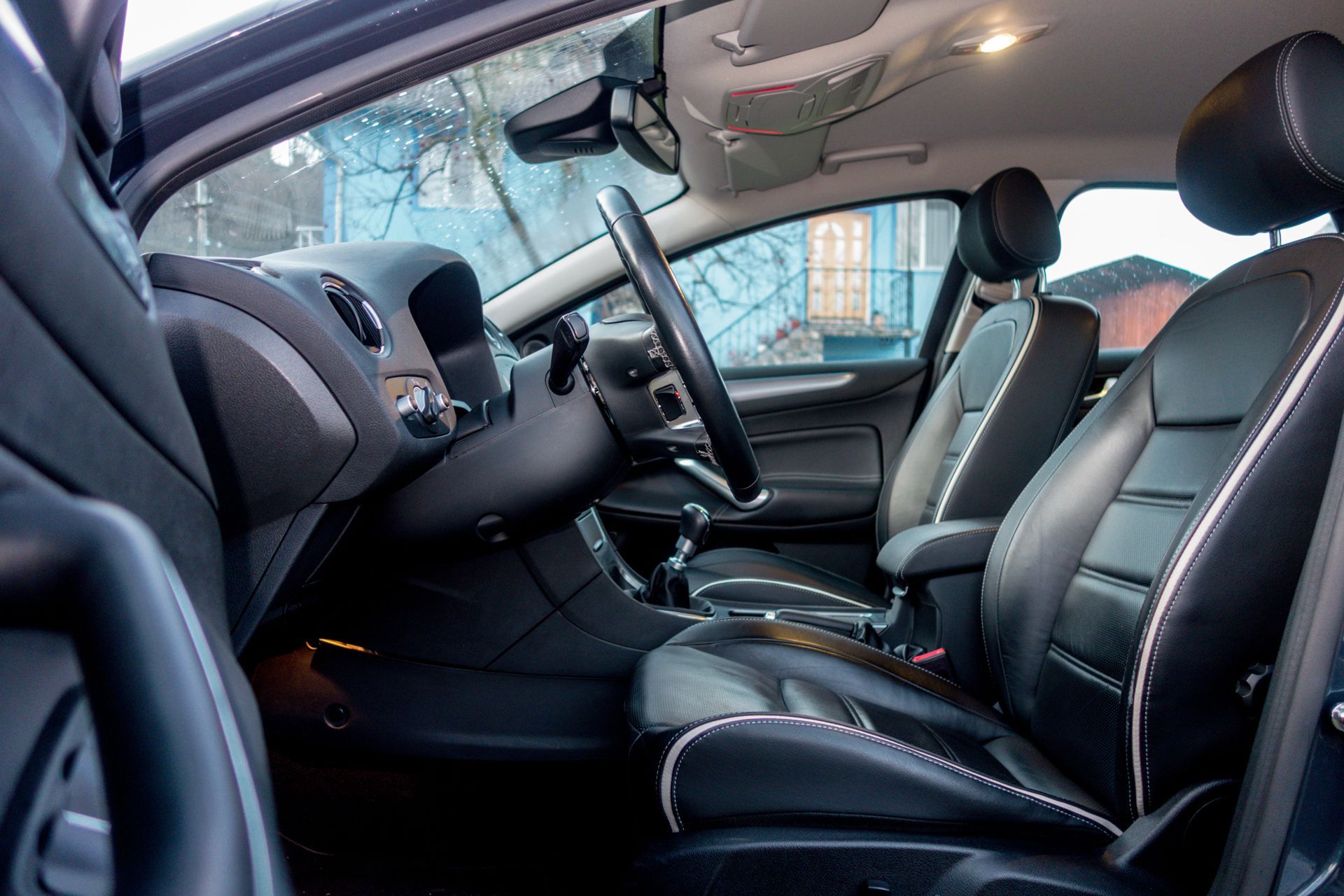 The Interior of a Car With Black Leather Seats and a Steering Wheel