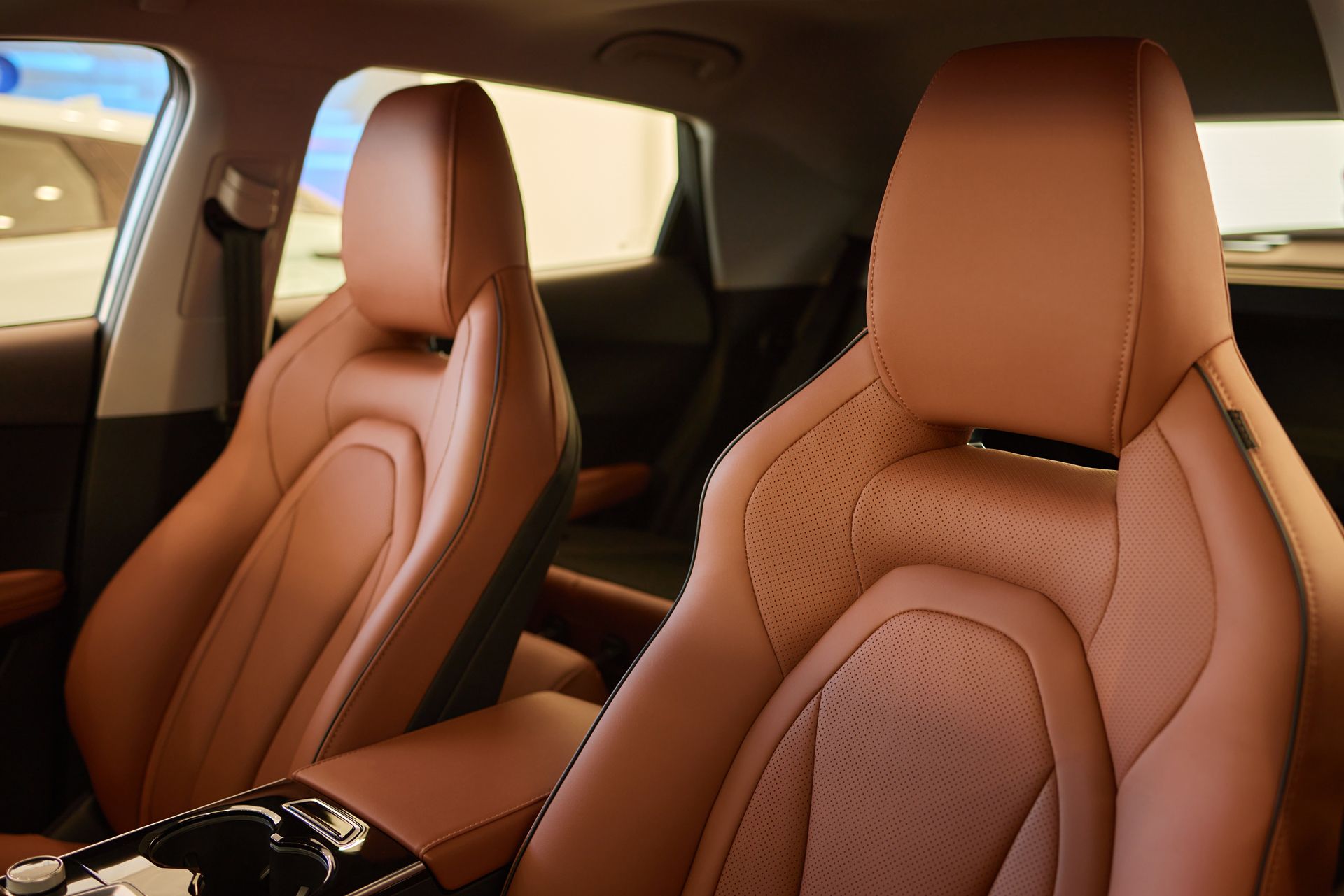 A Close Up of Two Brown Leather Seats in a Car