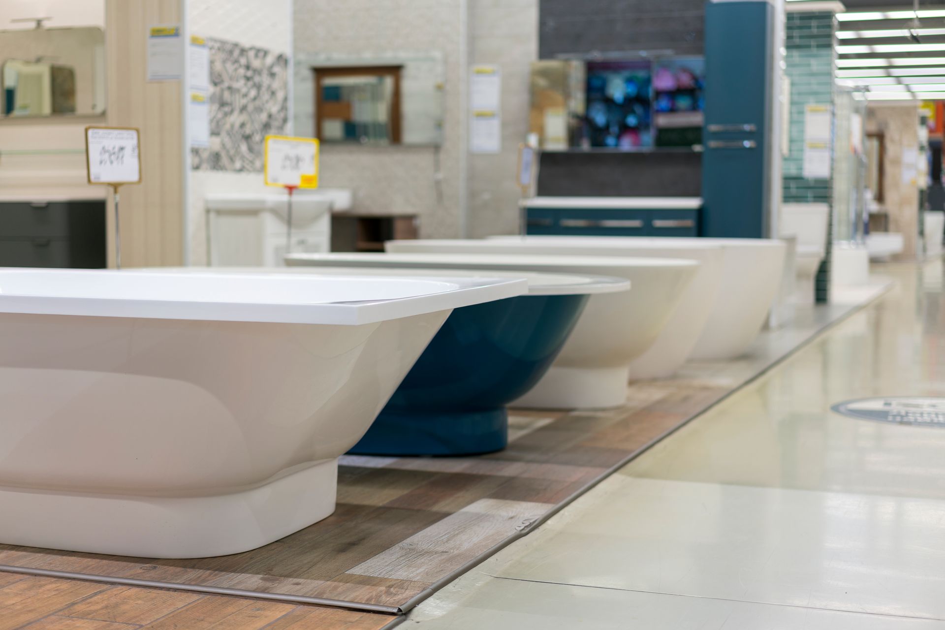 Showroom display of modern freestanding bathtubs in white and blue