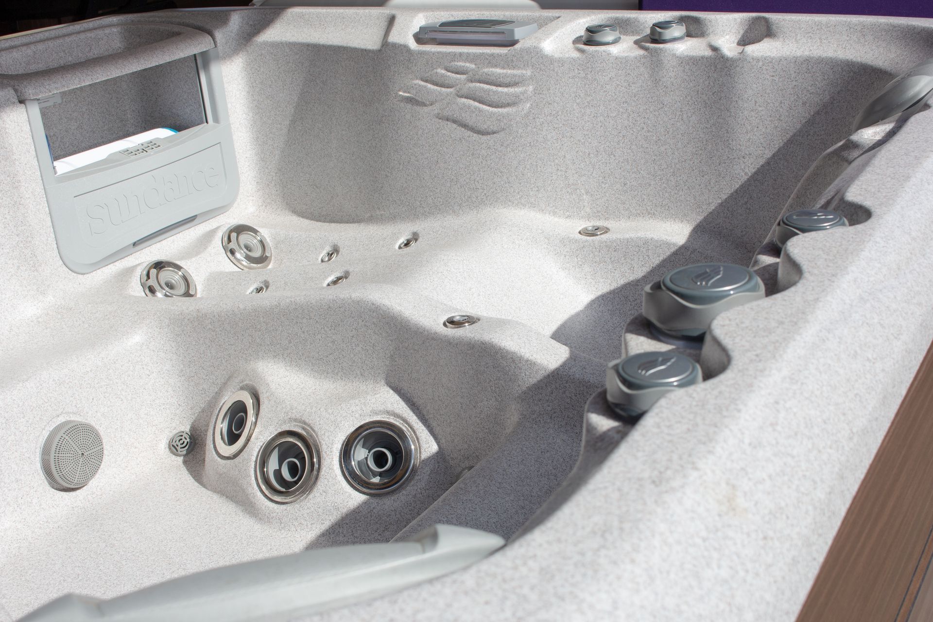 White spa hot tub with multiple jets and molded seats, shown in a close-up interior view