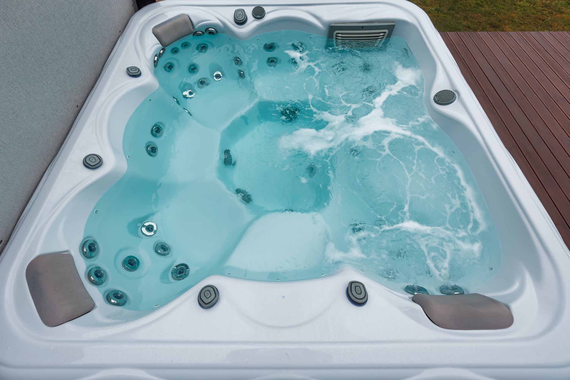 White spa hot tub with multiple jets and molded seats, shown in a close-up interior view