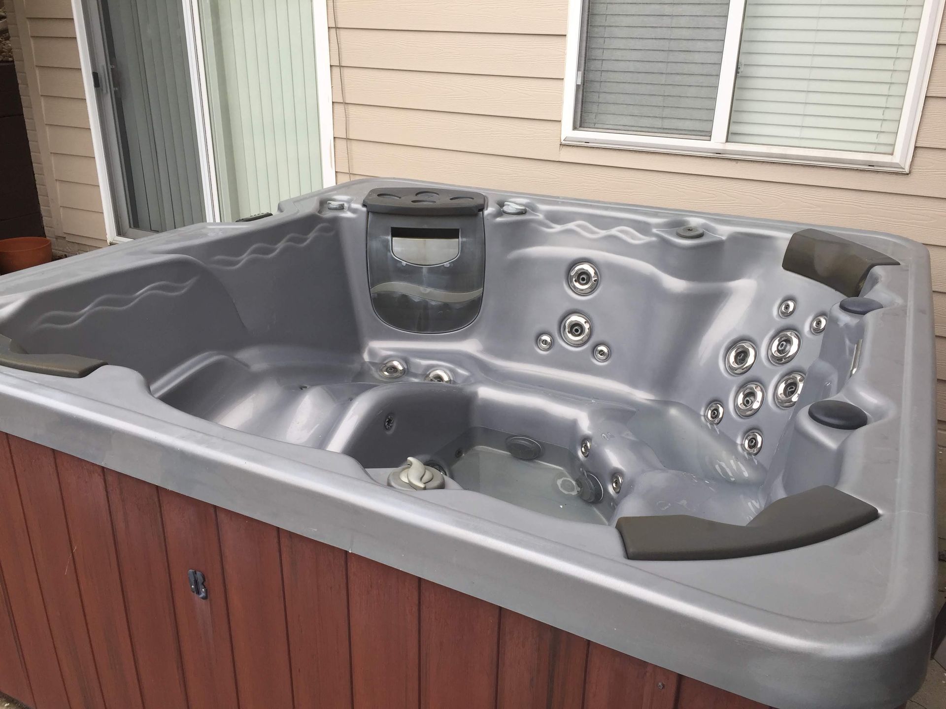 White spa hot tub with multiple jets and molded seats, shown in a close-up interior view