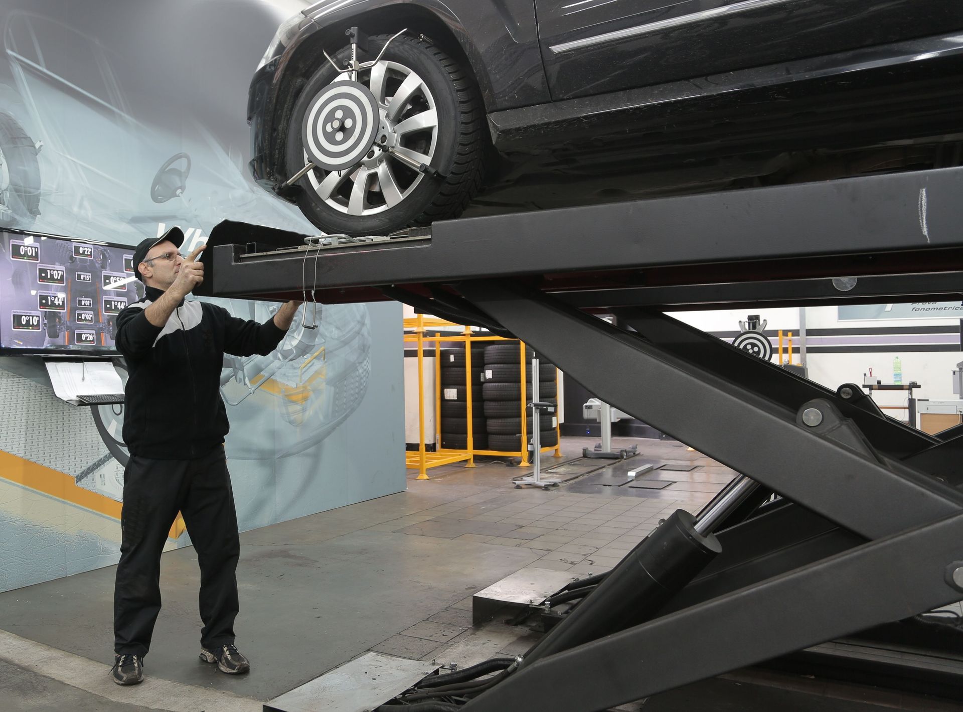 Mechanic Inspecting A Vehicle On An Automotive Lift | Simons Auto Service