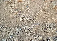Close-up of dry, rocky dirt ground with small pebbles and scattered gravel