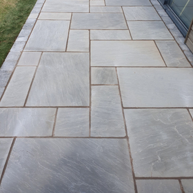 Gray stone paver walkway with rectangular tiles and subtle texture