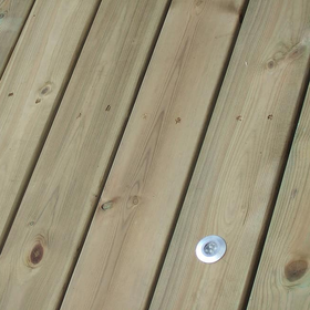 Close-up of weathered wooden deck boards with a metal screw head visible.