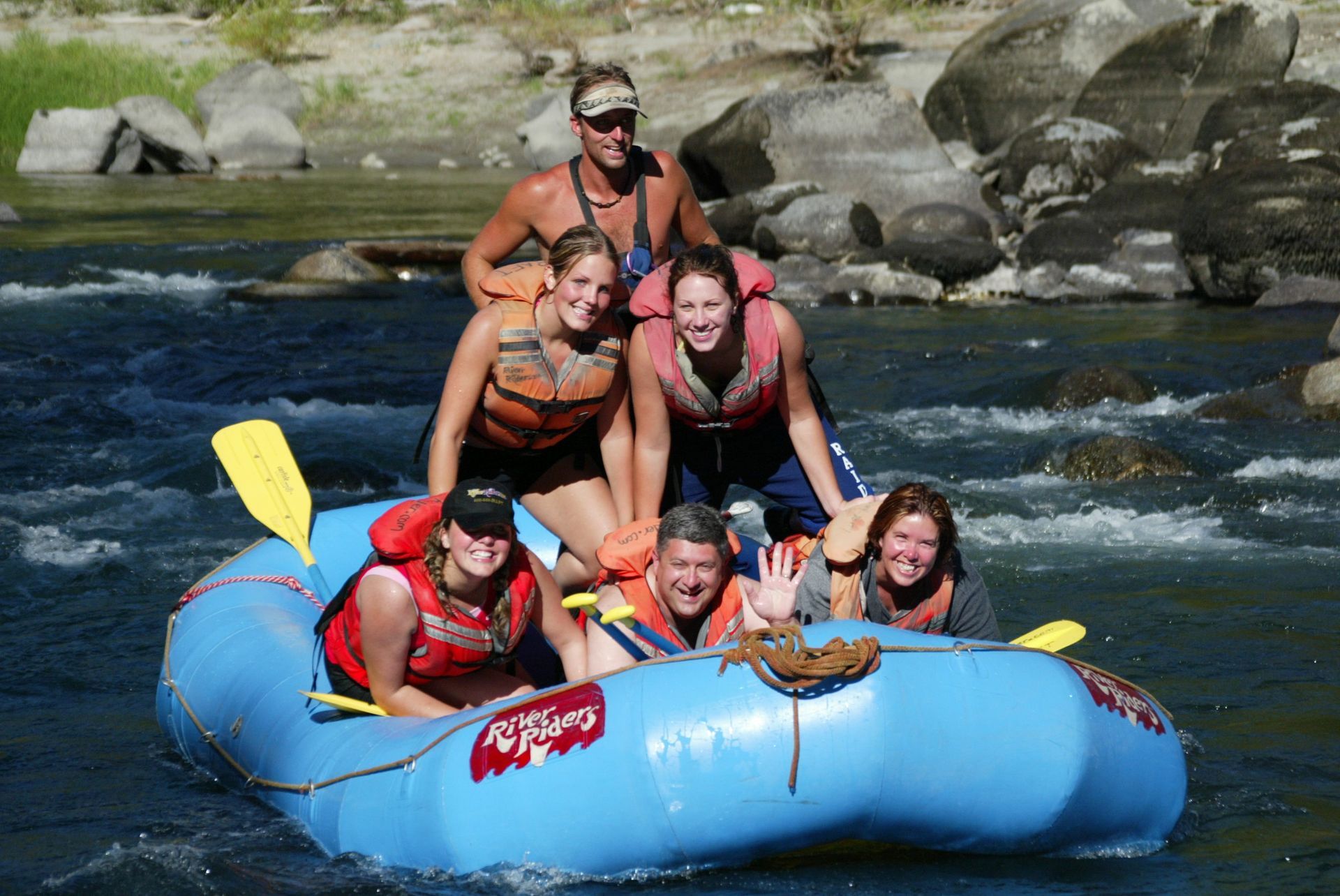 A group of people are riding a raft down a river.
