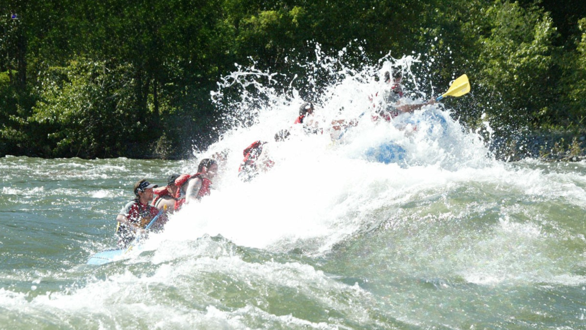 A group of people are rafting down a river